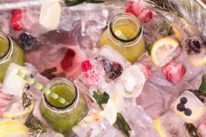 Lemonade stand blog - Cooler full of ice, fruit and lemonade
