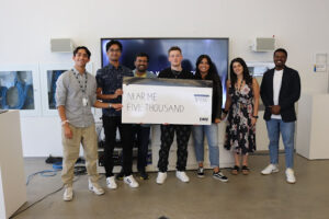A group of students from startup NearMe pose with their $5000 cheque